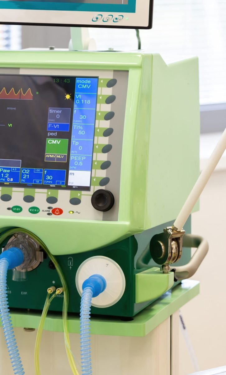 Monitor of pulmonary ventilator in hospital with tubes for air. Display with graphs used for artificial breathing assistance to patients on intensive care unit or during operations.